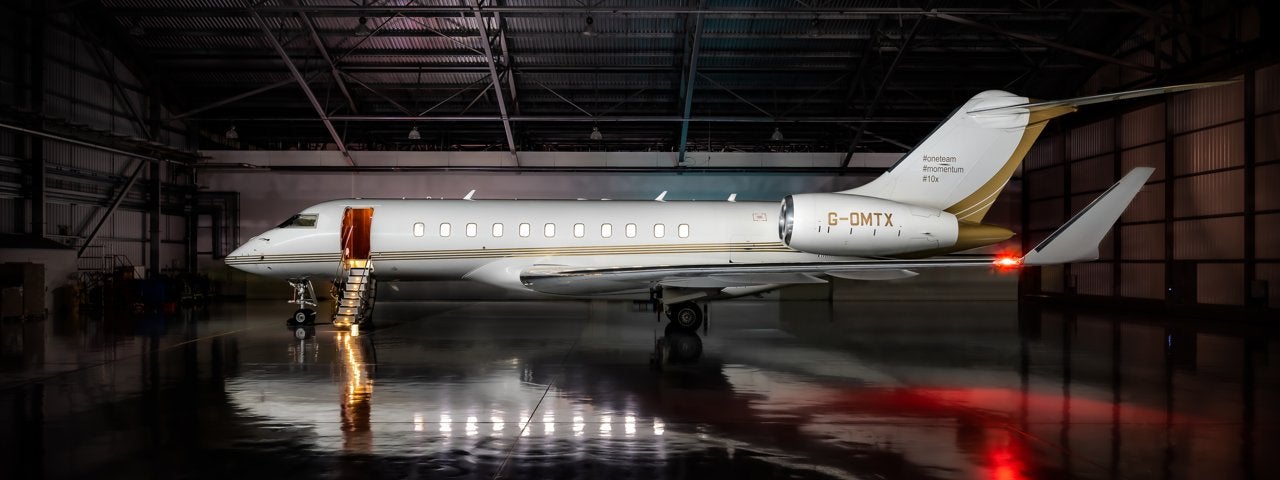  A Bombardier Global 5000 in a dark hangar.