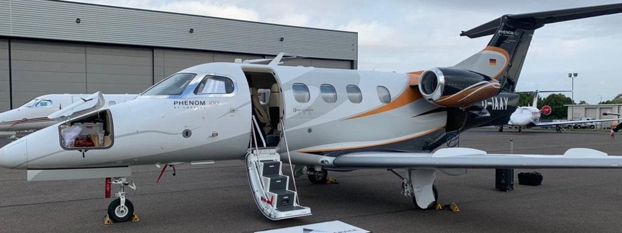 A photograph of a very light jet on the runway.