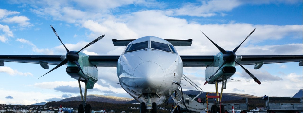 Turboprop passenger airplane parked at an airport