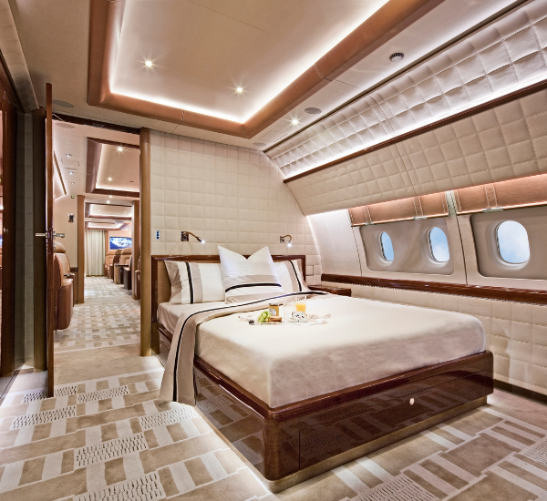 A luxurious bedroom with a double bed on an executive jet.