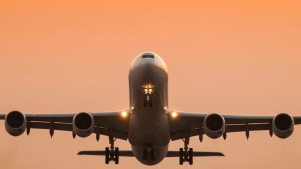 Heavy jet taking off into the sunset