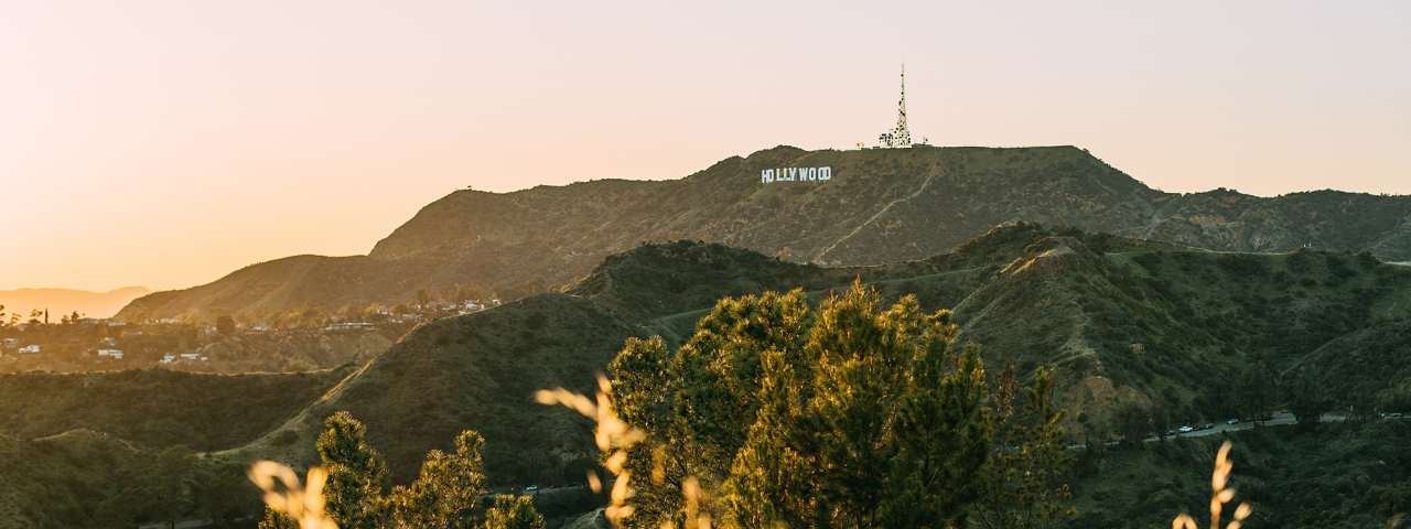 The Hollywood sign with the surrounding hills covered in sunset light